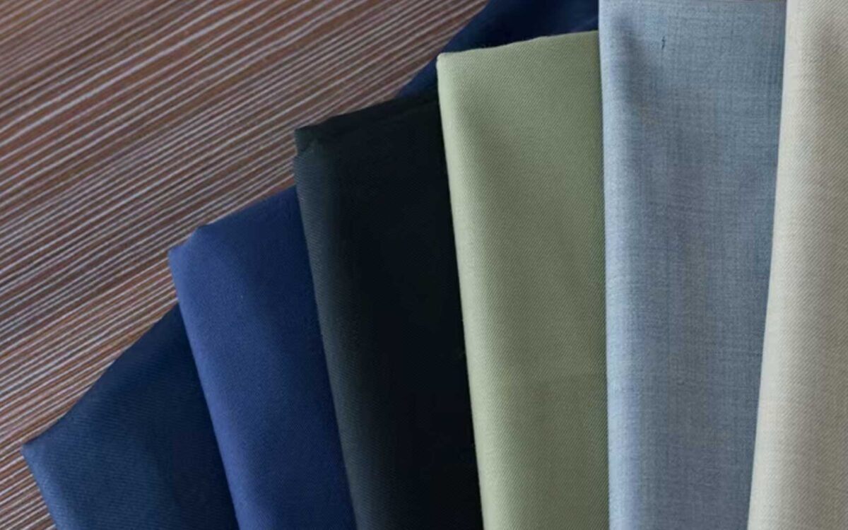 The $6 Fabric That Makes a $200 Suit Look Like $800 — And Why Most Corporate Uniforms Get This Wrong