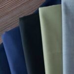 The $6 Fabric That Makes a $200 Suit Look Like $800 — And Why Most Corporate Uniforms Get This Wrong 65 35 poly viscose executive suit fabric for management uniforms